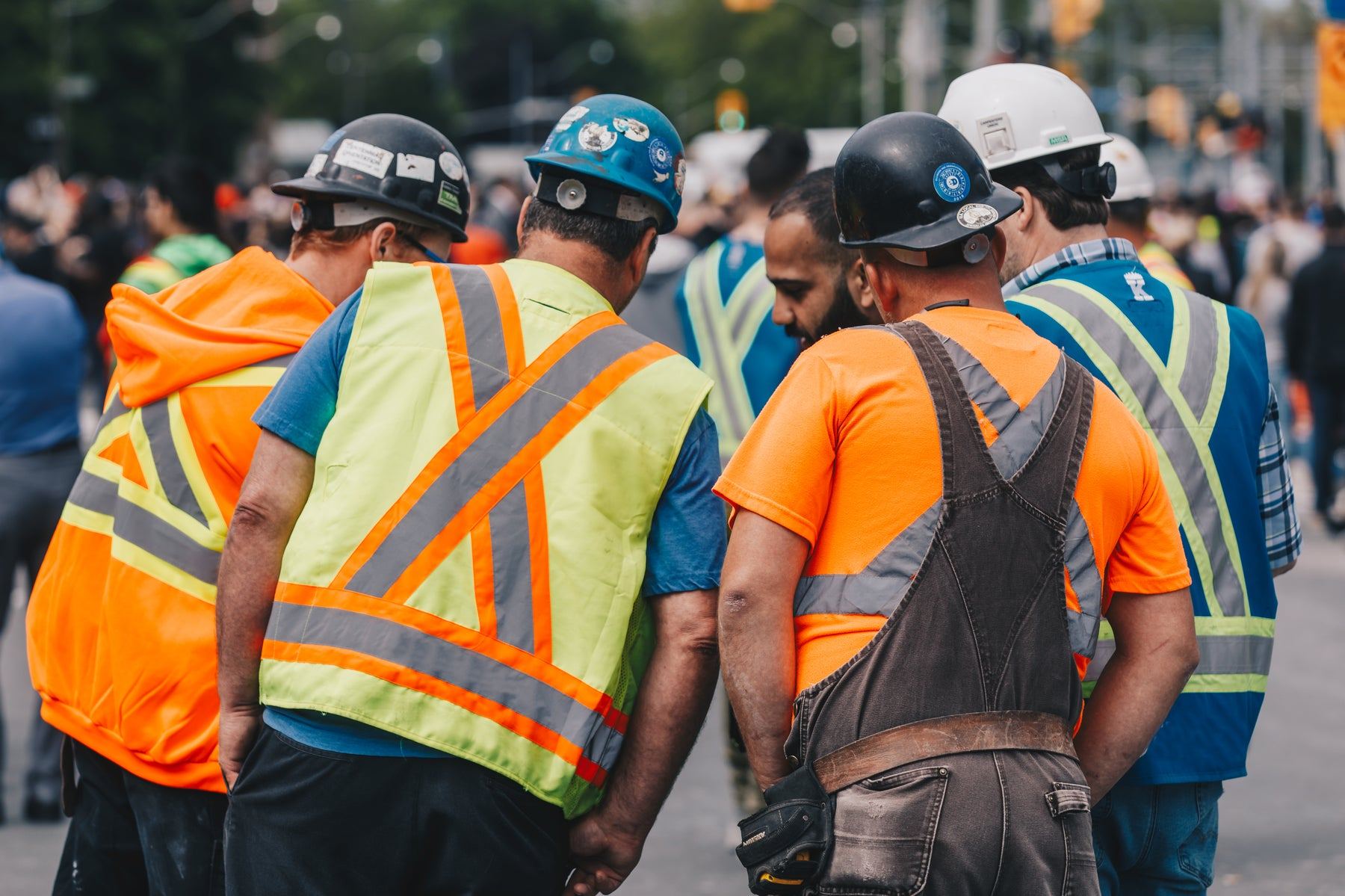 A crew of workers in hard hats and hi-vis vests